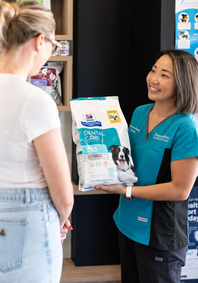 Our friendly team chatting with a happy client in our Coombabah vet clinic