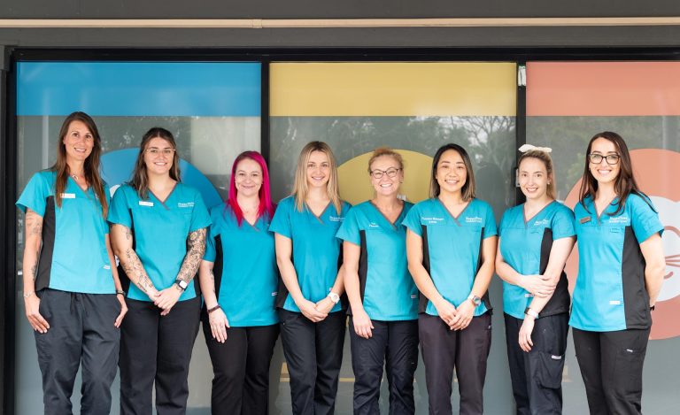 The Happy Paws Vet team standing in front of the Coombabah clinic